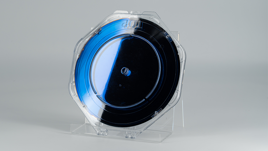 Disk-shaped non-metallic material coated with iconos™.
